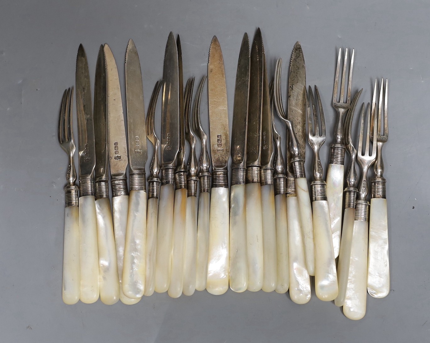 Eleven pairs of late Victorian mother of pearl handled silver dessert eaters, Mappin & Webb, Sheffield, 1894.